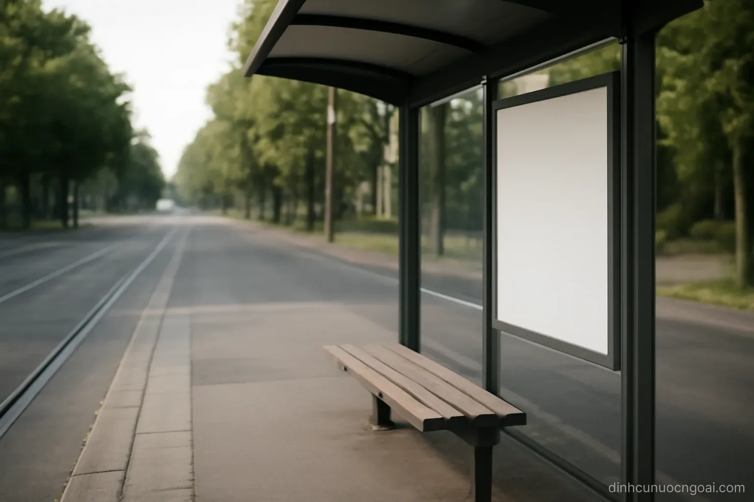 a tram stop shelter with an empty bench and a blank information panel, street stretching away behind it